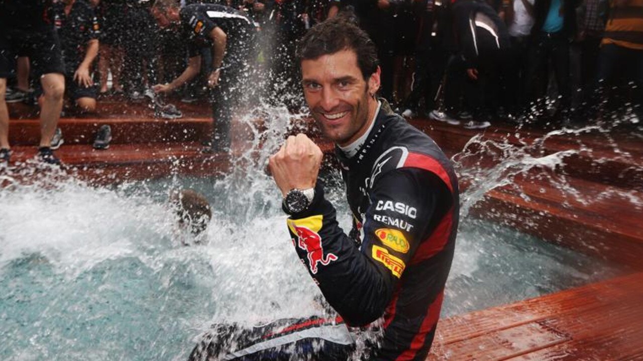 Mark Webber celebrates winning the race by jumping into the swimming pool on the Red Bull Energy Station.