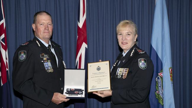 Queensland Police Service Central Region Assistant Commissioner Kevin Guteridge is presented with his appointment certificates and epaulettes at a recent ceremony by Commissioner Katarina Carroll.