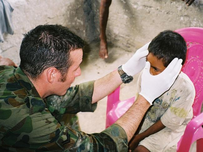 Voodoo Medicine wasn’t always the main focus for Brad Watts. Here he is pictured treating a young Afghani boy