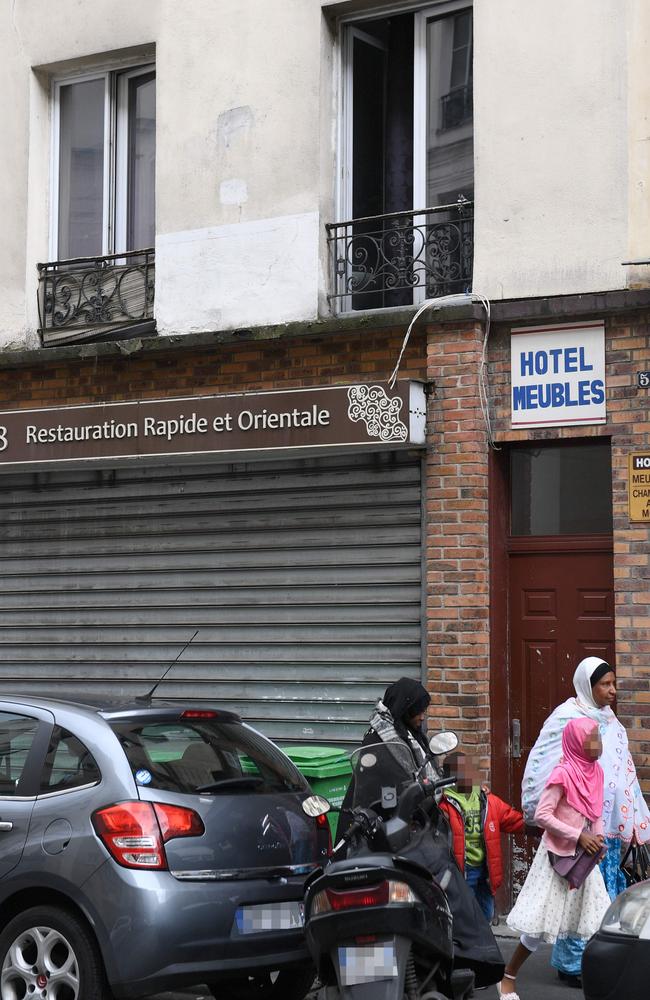 People walk past the Hotel Meubles in central Paris where the parents of a man who killed one person and wounded four others live. Picture: AFP