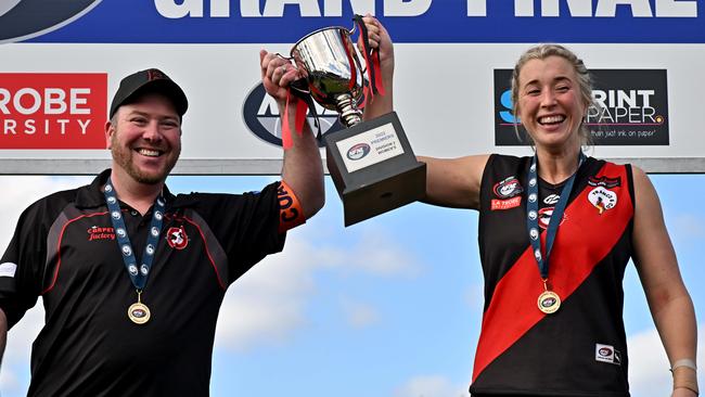 NFL: Eltham coach David Craig and captain Jacki White hold the premiership cup. Picture: Andy Brownbill