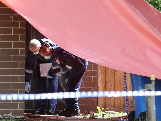 Forensics investigators outside the house. Picture Yuri Kouzmin