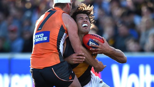 Alex Rance gets crunched by Steve Johnson.