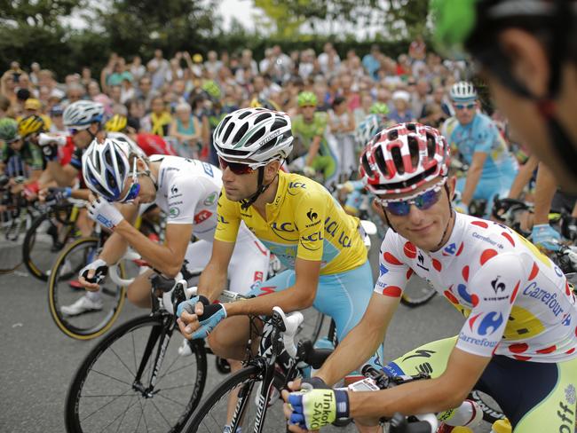 France's Thibaut Pinot, wearing the best young rider's white jersey, Vincenzo Nibali, wearing the overall leader's yellow jersey, and Poland's Rafal Majka, wearing the best climber's dotted jersey.