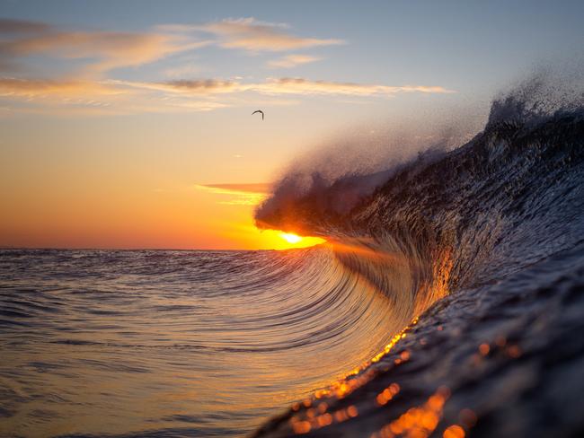 Keelan positions himself on the edge of the wave ready for that perfect shot. Picture: Warren Keelan