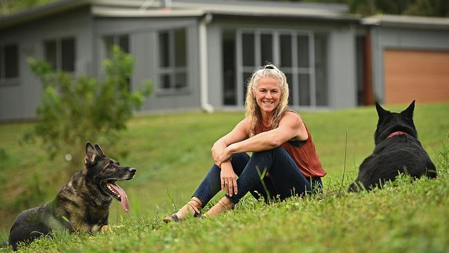 Kellie Ker relaxes with her dogs, Johnny and Peachy at her home in Tallebudgera Valley, west of the Gold Coast. Thirty registered bidders competed for Kellie Ker's acerage home in the Gold Coast hinterland. Picture: Lyndon Mechielsen/ The Australian