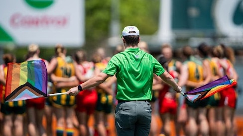A goal umpire waving their Pride Round flags during the Round 6 match between Waratah and PINT. Picture: Pema Tamang Pakhrin