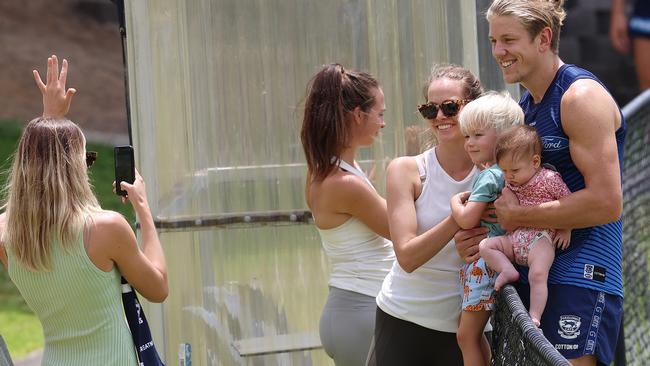 Geelong ruckman Rhys Stanley and his wife Kirsten pose for a family photo after training on the Gold Coast this week. Picture: Michael Klein