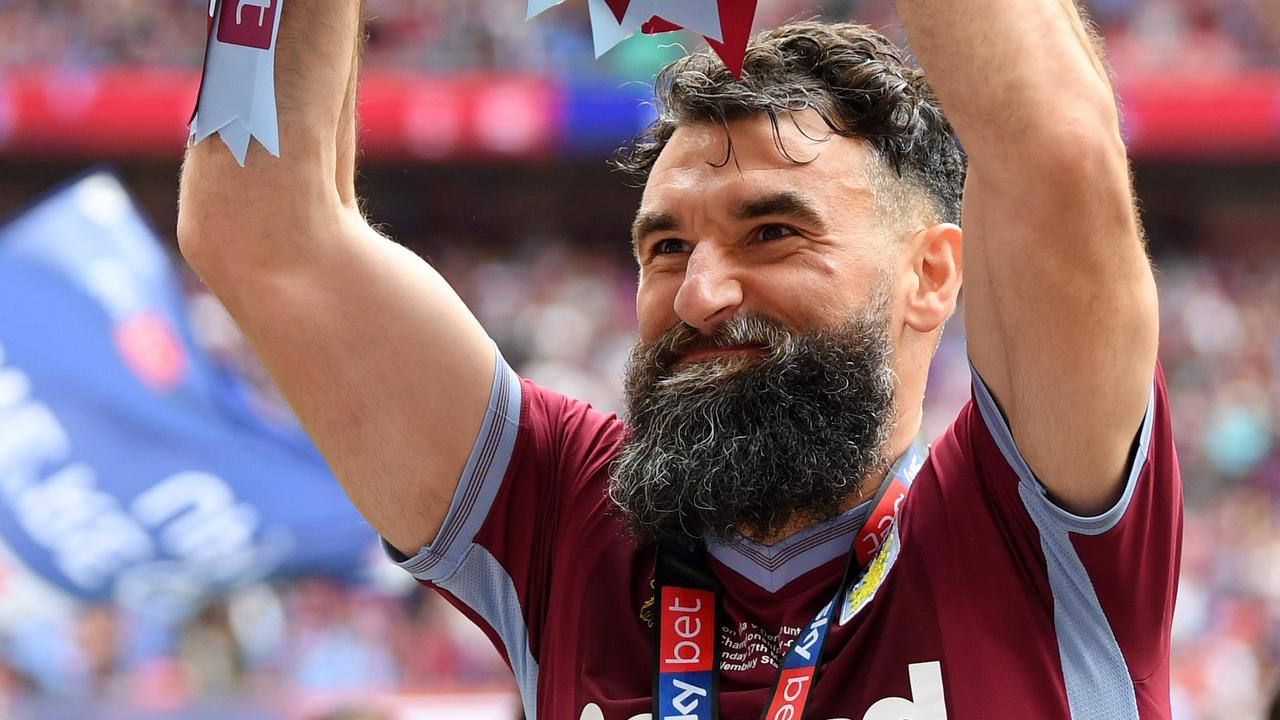 Mile Jedinak celebrates after helping Aston Villa secure promotion back to the Premier League.