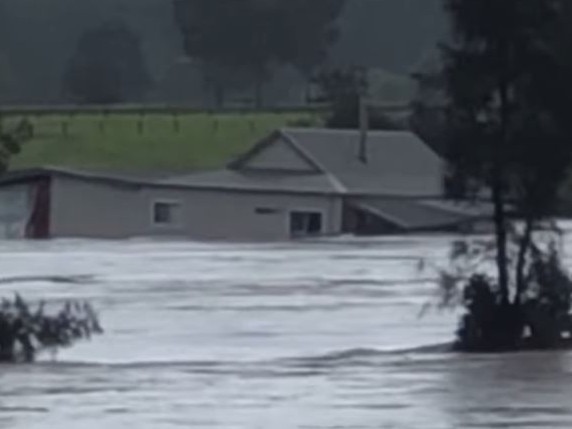 House being swept away in floodwaters near Taree. Source: Facebook