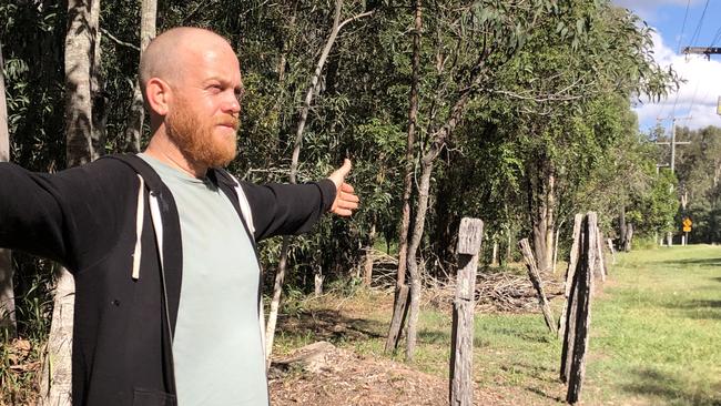 Chambers Flat resident Anthony Aitken at the front of his parents’ property which is being resumed to widen Chambers Flat Rd.