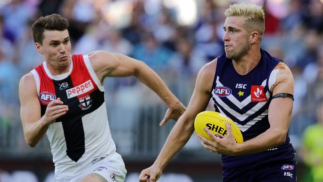 Blake Acres of the Saints chases Luke Ryan of the Dockers.