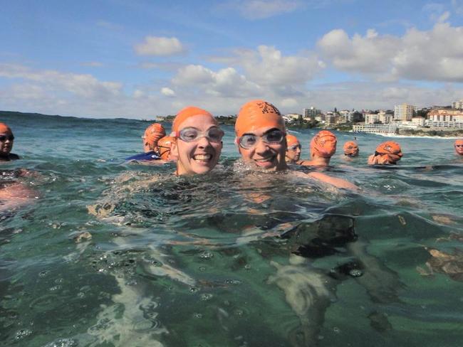 Can Too swimmers in the surf.