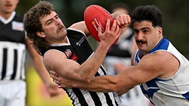 EDFL: Moonee Valley’s Gabriel Clements can’t escape John Corso of Sunbury Kangaroos. Picture: Andy Brownbill