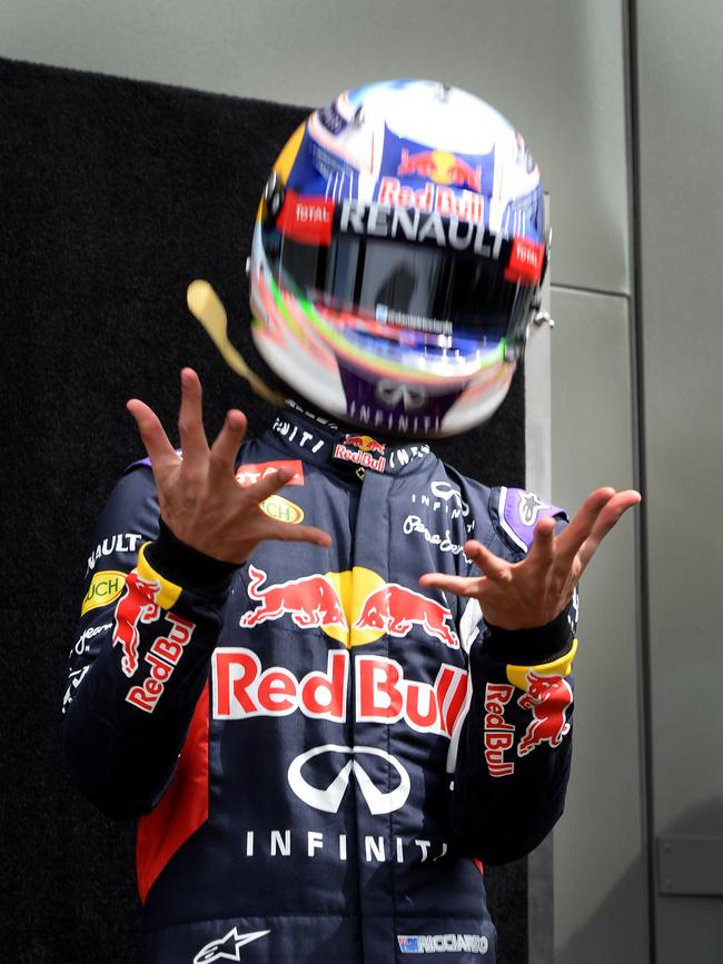 Australian driver Daniel Ricciardo catches his helmet after throwing it into the air as he poses for the start of season driver portrait session ahead of the Australian Formula One Grand Prix in Melbourne. Picture: AFP/Mal Fairclough
