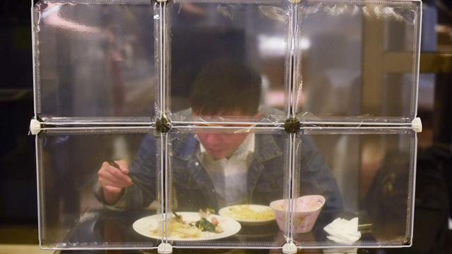 A restaurant seperates diners with table partitions in Ningbo, in eastern China's Zhejiang province. Picture: AFP