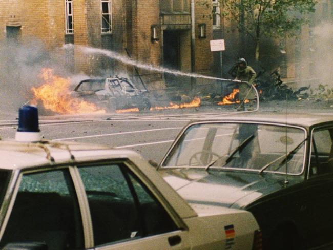 A fire fighter in protective gear fights the city blaze in 1986.