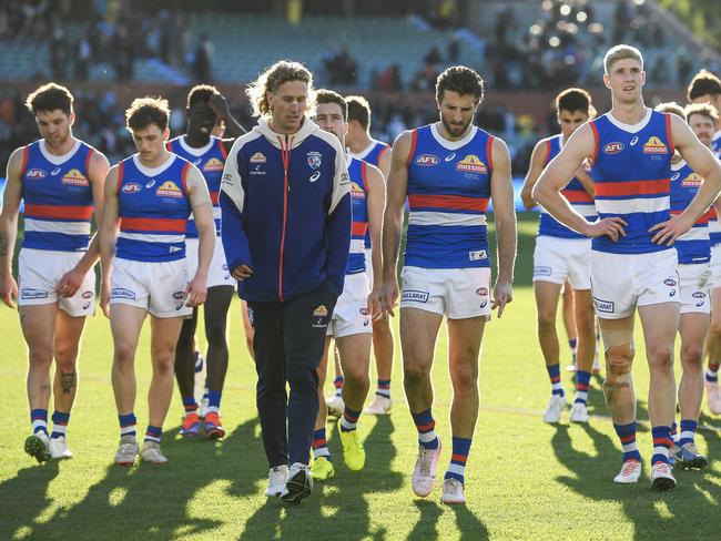 ADELAIDE, AUSTRALIA - JULY 06:  Aaron Naughton , Marcus Bontempelli and  Tim English of the Bulldogs  lead  their team off after losing the round 17 AFL match between Port Adelaide Power and Western Bulldogs at Adelaide Oval, on July 06, 2024, in Adelaide, Australia. (Photo by Mark Brake/Getty Images)