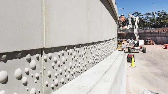 Concrete panels on the side of the almost completed Warringah Rd underpass, depict bubbles inside a crashing wave as part of the "Gateway to the Beaches" urban design theme. Picture: Transport for NSW