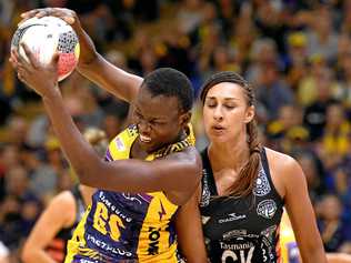 Peace Proscovia of the Lightning catches the ball ahead of Magpies player Geva Mentor. Picture: Bradley Kanaris