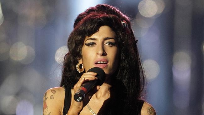 Released in 2003, what was the name of English singer-songwriter Amy Winehouse’s debut album? Photo by Shaun Curry / AFP