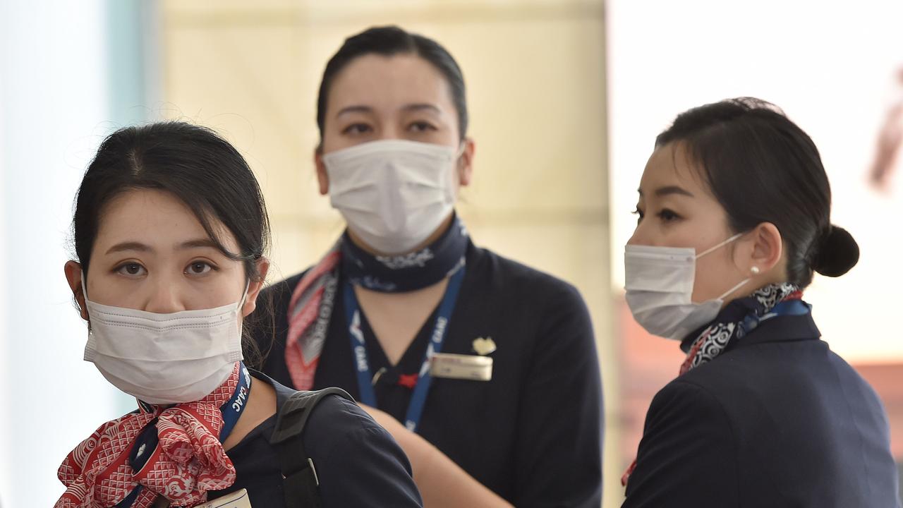 China Eastern Airlines aircrew arrive at Sydney airport after landing on a plane from Shanghai on January 25, 2020. Picture: Peter Parks/AFP