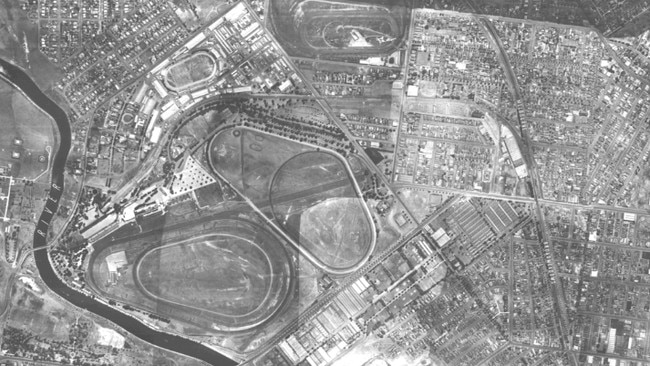 This 1945 aerial photograph shows Ascot Racecourse at the top of the shot, with two tracks at Flemington clearly visible in the middle and the old Kensington abattoirs at the bottom. Picture: State Library of Victoria