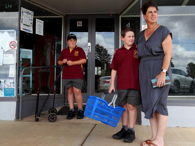 Local mum Jo Charlton with her sons Sam 13 and Josh 9 outside the closed store. Picture: Toby Zerna