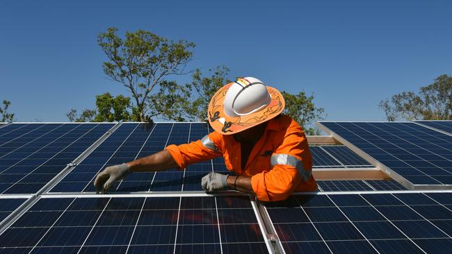 Northern Territory workers install solar panels in Daly River, Friday, August 11, 2017. (AAP Image/Lucy Hughes Jones) NO ARCHIVING