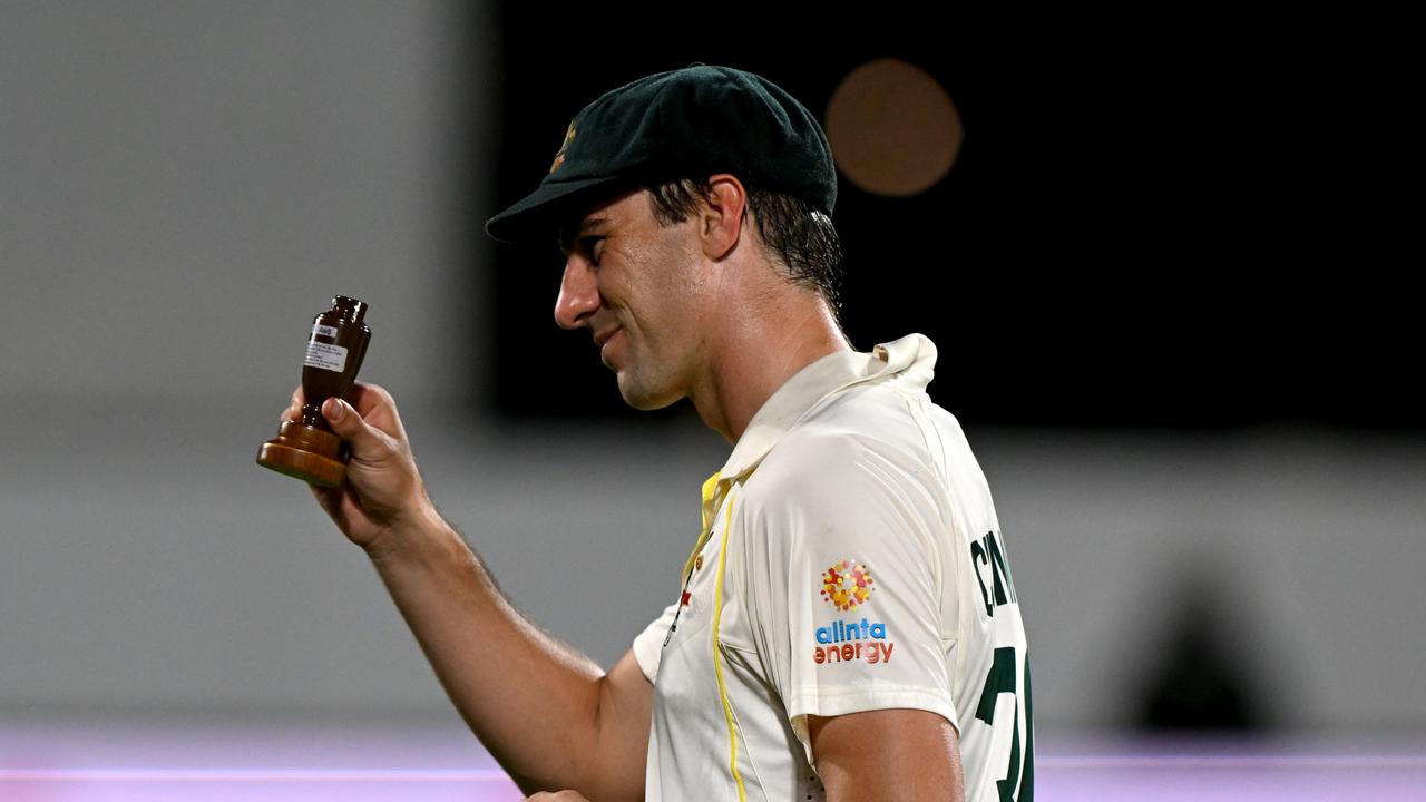 HOBART, AUSTRALIA - JANUARY 16: Pat Cummins of Australia celebrates with the Ashes after winning the Fifth Test in the Ashes series between Australia and England at Blundstone Arena on January 16, 2022 in Hobart, Australia. (Photo by Steve Bell/Getty Images)