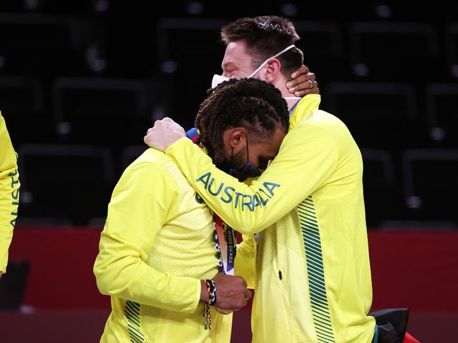 SAITAMA, JAPAN - AUGUST 07: Patty Mills and teammate Matthew Delavedova hug one another during the Men's Basketball medal ceremony on day fifteen of the Tokyo 2020 Olympic Games at Saitama Super Arena on August 07, 2021 in Saitama, Japan. (Photo by Kevin C. Cox/Getty Images)