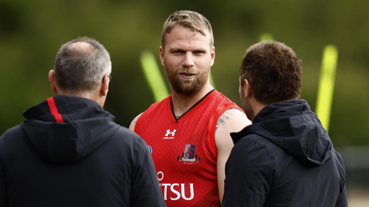 Jake Stringer chats to Essendon coaches. Picture: Darrian Traynor/Getty Images