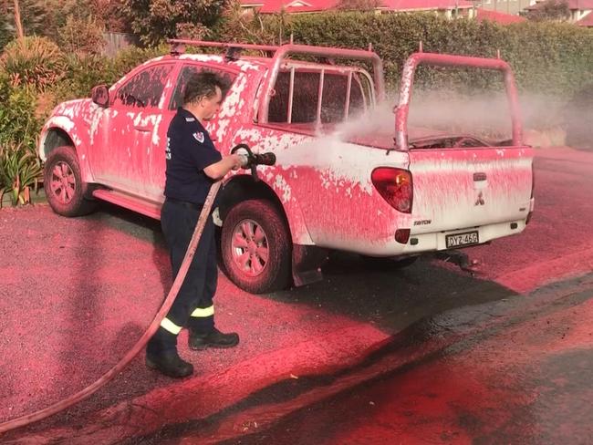 A firefighting plane drops fire retardant on the Sydney suburb of South Turramurra where fires were threatening homes. Picture: Seven News