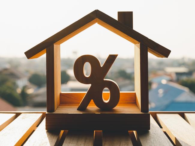 Percentage and house sign symbol icon wooden on wood table. Concepts of home interest, real estate, investing in inflation. mortgage home loan interest rates generic