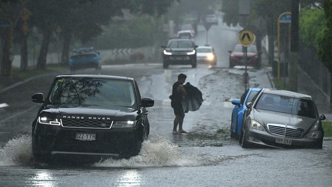 BRISBANE, AUSTRALIA - MARCH 09: Cars drive through Widdop Street in the suburb of Clayfield on March 09, 2025 in Brisbane, Australia. Australia's east coast is experiencing severe weather as ex-Tropical Cyclone Alfred moves south. While downgraded from cyclone status, the weather system continues to bring damaging winds, heavy rainfall, and flash flooding, particularly in the Gold Coast and northern NSW regions. Authorities have issued severe weather warnings, and coastal areas remain at risk of significant erosion and hazardous surf conditions. Residents are urged to stay updated on local warnings, avoid floodwaters, and prepare for ongoing disruptions. (Photo by Albert Perez/Getty Images)