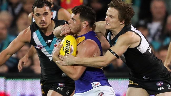 Luke Shuey earned a free kick after this tackle from Port midfielder Jared Polec. Picture: Getty Images