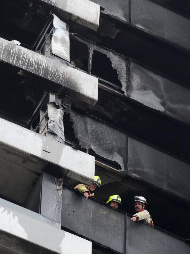 Fire crews at the singed apartment block. Picture: Andrew Henshaw