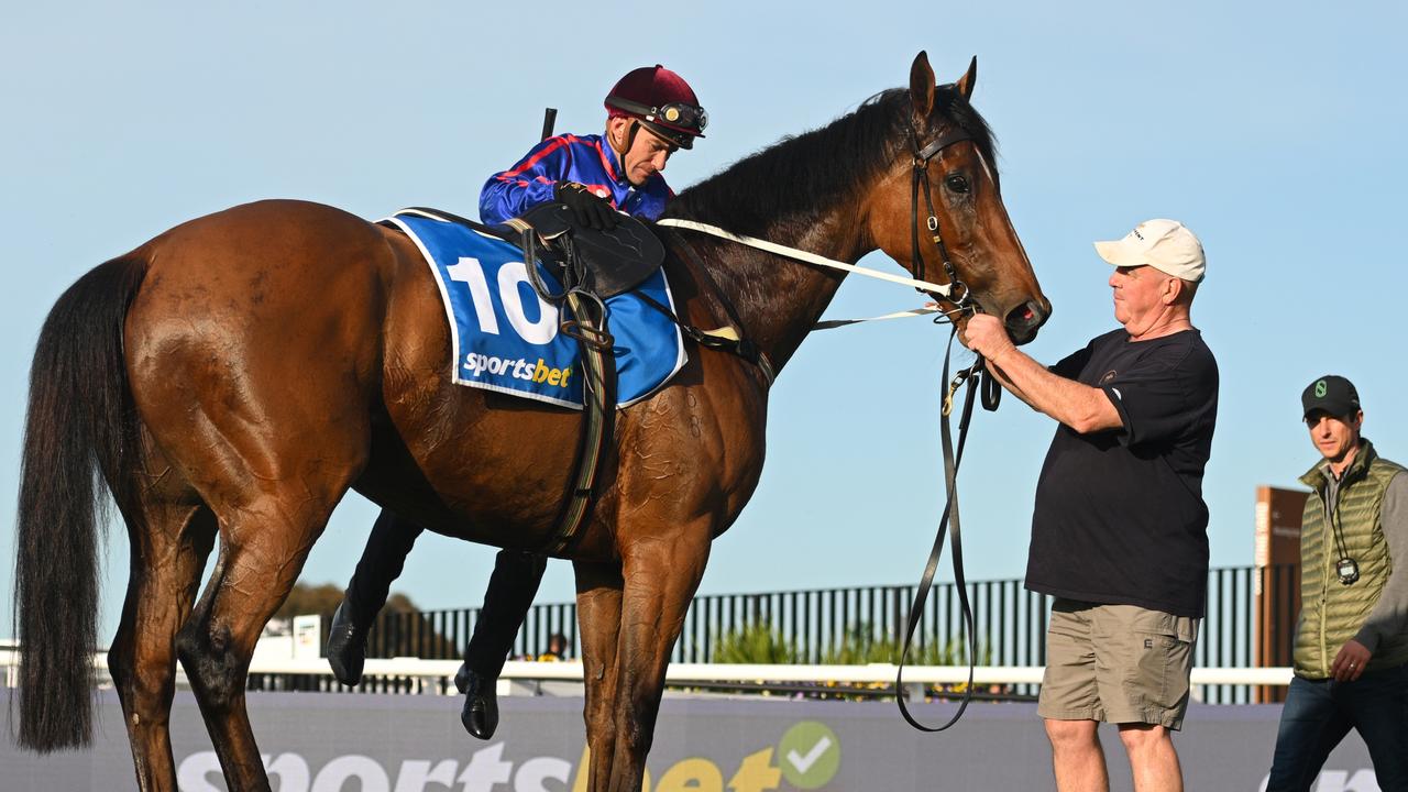 Luke Currie dismounting after riding Globe during Caulfield Cup Gallops at Caulfield on Tuesday morning. Picture: Vince Caligiuri/Getty Images