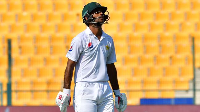 Pakistan’s Fakhar Zaman leaves the pitch yesterday after becoming Nathan Lyon’s latest victim. Picture: AFP