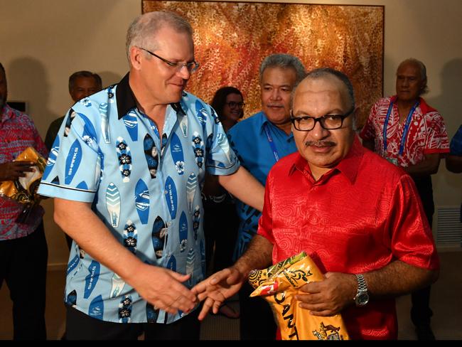 Australia's Prime Minister Scott Morrison gives Papua New Guinea Prime Minister Peter O'Neill a Wallabies rugby union jersey at a barbeque for Pacific Islands leaders at the Australian High Commission after the 2018 Asia-Pacific Economic Cooperation (APEC) forum in Port Moresby, Papua New Guinea, Sunday, November 18, 2018. (AAP Image/Mick Tsikas) NO ARCHIVING