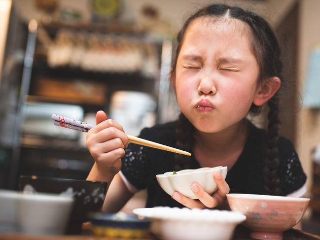 Girl eating Japanese food at home