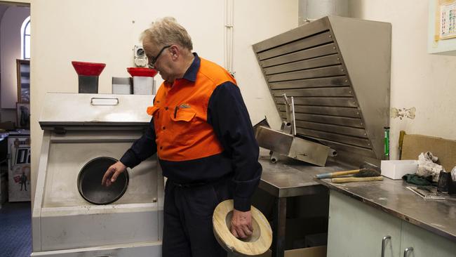 Crematorium operator David Bennett explains how the “action processor” machine grinds down calcified bones after cremation. Picture: Keri Megelus/news.com.au