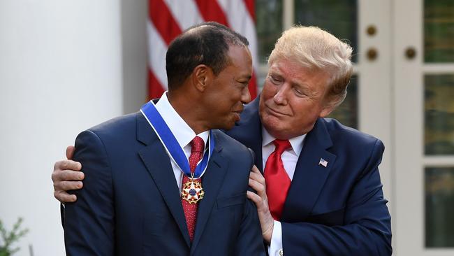 US President Donald Trump presents US golfer Tiger Woods with the Presidential Medal of Freedom during a ceremony in the Rose Garden of the White House in Washington, DC, on May 6, 2019. (Photo by SAUL LOEB / AFP)