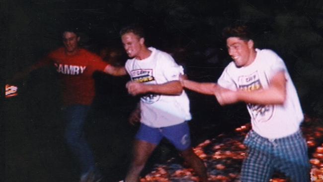 Nigel Smart walks over hot coals during a Crows motivational exercise in 1992.