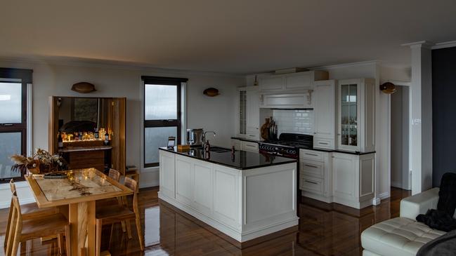 The Keep's luxurious living area featuring cook's kitchen, well-stocked drinks cabinet made by Tasmanian designer Simon Ancher, and dining area. Picture: Christian Watson