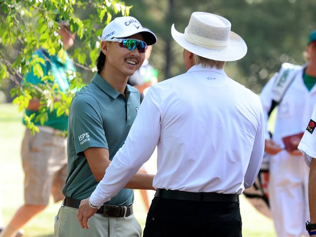 AUGUSTA, GEORGIA - APRIL 10: Greg Norman of Australia The Commissioner of the LIV Golf Tour says hello to Min Woo Lee of Australia in amongst the patrons during a practice round prior to the 2024 Masters Tournament at Augusta National Golf Club on April 10, 2024 in Augusta, Georgia. (Photo by David Cannon/Getty Images)