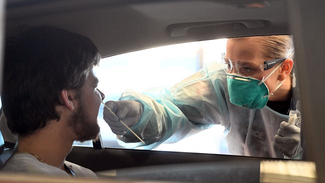 A member of the Australian Defence Force takes a swab for a COVID-19 test.