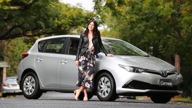 Eliza Gieck with a Toyota Corolla, which is cheaper to buy today than it was 10 years ago. Picture: Tait Schmaal