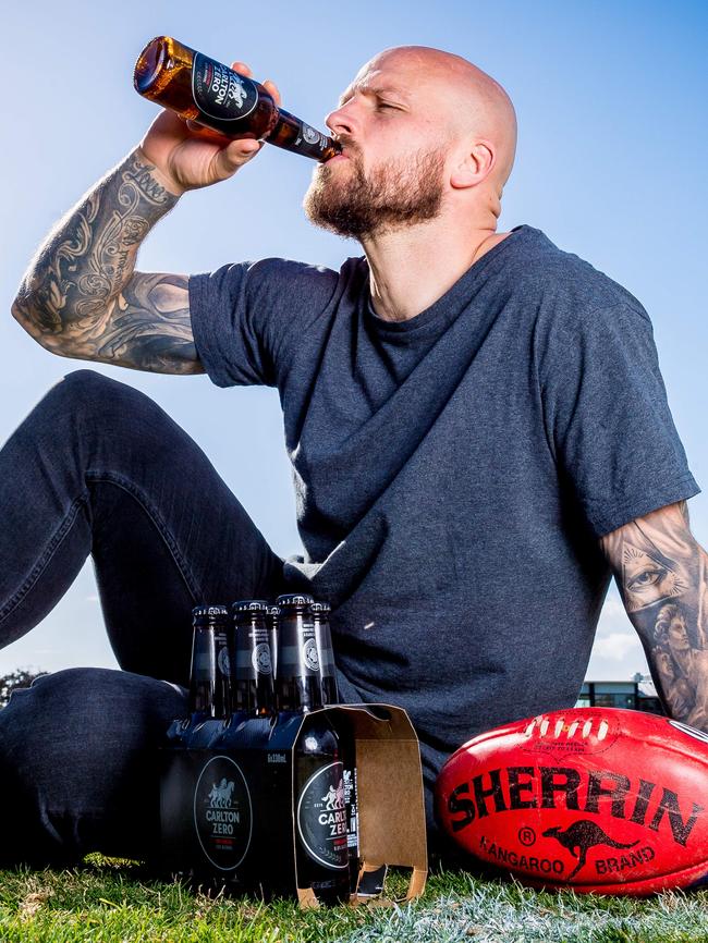 Melbourne captain Nathan Jones samples the new CUB Carlton Zero beer. Picture: Jake Nowakowski