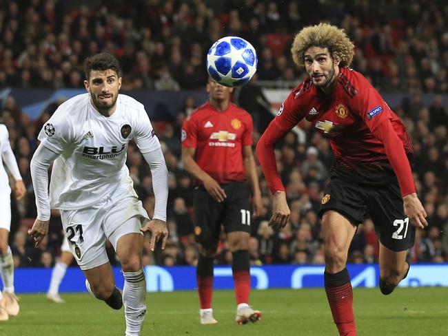 ManU midfielder Marouane Fellaini, right, runs for the ball with Valencia defender Cristiano Picciniduring the Champions League group H soccer match between Manchester United and Valencia at Old Trafford Stadium in Manchester, England, Tuesday Oct. 2, 2018. (AP Photo/Jon Super)